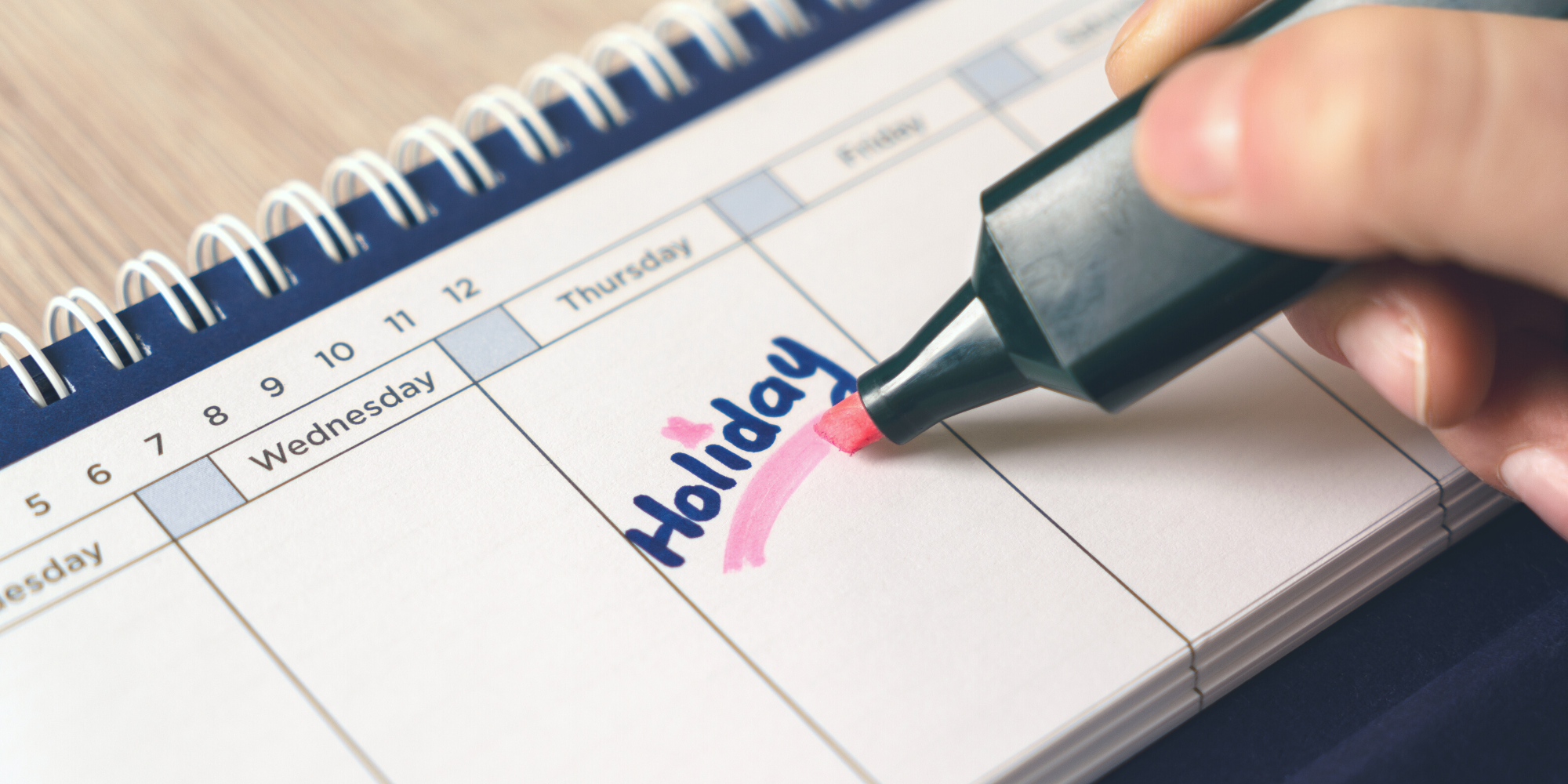 Holiday written in blue sharpie on calendar